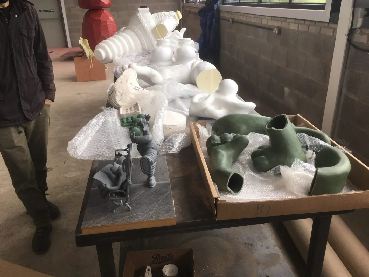 Printed pattern sections of a large sculpture laid out on a bench